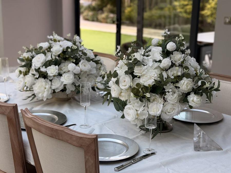 Two centrepieces set down a long table at a venue