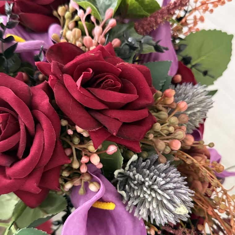 Deep red roses with purple calla lilies
