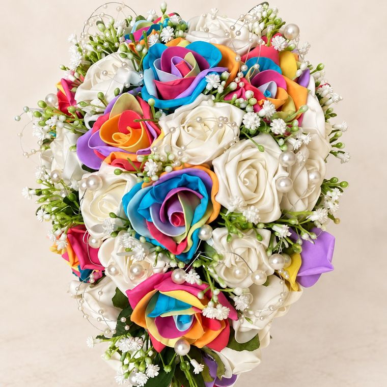 A teardrop of rainbow and ivory roses with pearls