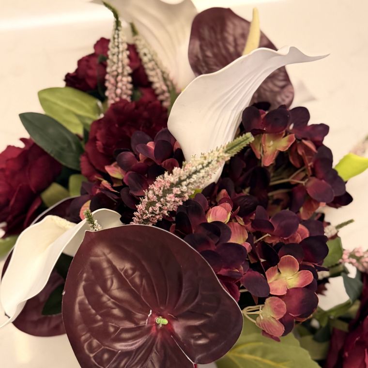 Wine roses and dark hydrangea with a white calla lily